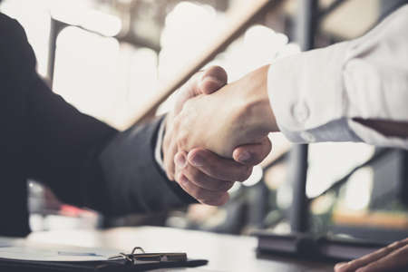 Meeting and greeting concept, Two confident Business handshake and business people after discussing good deal of Trading contract and new projects for both companies, success, partnership, co worker.の写真素材