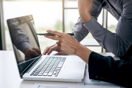 Co working conference, Business team meeting present, investor colleagues discussing new plan financial graph data on office table with laptop and digital tablet, Finance, accounting, investment.の写真素材