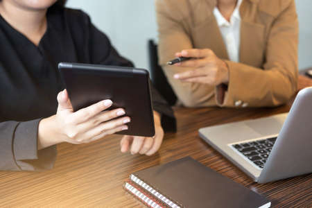 Business team meeting working with new startup project, discussion and analysis data the charts and graphs. Digital tablet calculator, laptop computer using, Business finances and accounting concept.の写真素材