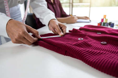 Fashion designer colleagues working and project of drawing sketches for clothes in workplace with laptop, digital tablet and color charts, Fashion Designer Stylish Concept.の写真素材