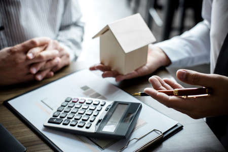 Real estate broker agent being analysis and making the decision a home estate loan to customer,...