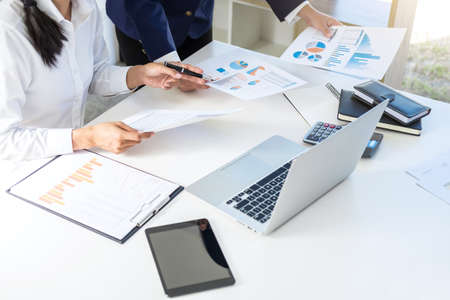 Teamwork of business colleagues consultation market growth on financial document graph report, professional occupation working analyzing startup and investment project to development grow to success.の写真素材