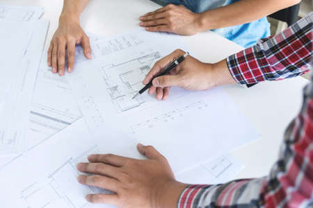 Architect working on blueprint, Engineer meeting working with partner colleagues and engineering...