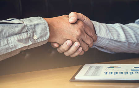 Meeting and greeting, Two executive businessman handshake after consultation and conference new business strategy plan, Trading contract and new projects for both companies, success, partnership.の写真素材
