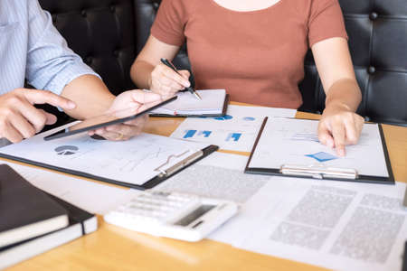 Business team two executive colleagues discussing and analysis working Financial investment on...