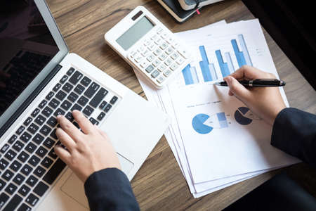 Professional business woman working with calculator, Doing finance on laptop, document graph and analysis business strategy to development profit.の写真素材