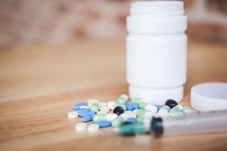 Medicine supplement and drug on wooden background, Close up of capsule, syringe and different kind...