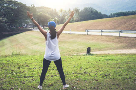 Attractive young muscular women, Athletic woman doing some stretching exercises warm up before start running.の写真素材