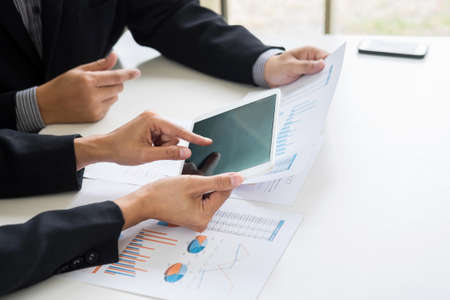 Business team meeting working with new startup project, discussion and analysis data the charts and graphs. Digital tablet calculator, laptop computer using, Business finances and accounting concept.の写真素材