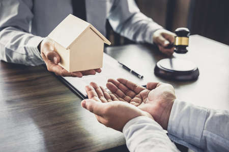 Home loan insurance, Male lawyer or judge Consult with client and working with Law books, report the case on table in office, Law and justice concept.の写真素材