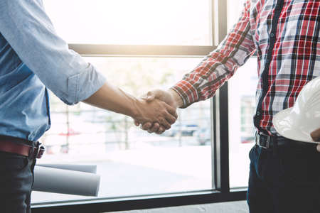 Meeting and greeting, Two engineer or architect meeting for project, handshake after consultation and conference new project plan, contract for both companies, success, partnership.の写真素材