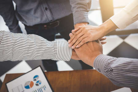 Business partnership meeting, Image of business people joining and putting hands together during...