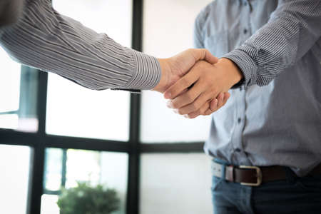 Business partnership meeting concept, Two confident Business handshake and business people after discussing good deal of Trading contract and new projects for both companies, success, partnership.の写真素材