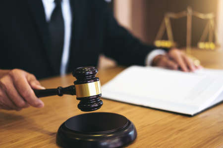 Judge gavel with Justice lawyers, Businessman in suit or lawyer working on a documents. Legal law, advice and justice concept.の写真素材