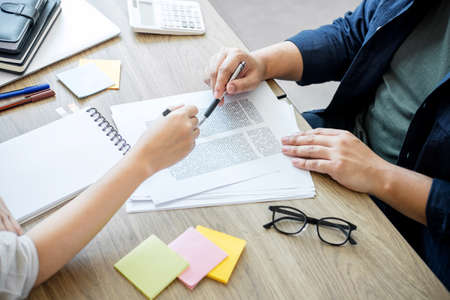 Two high school students campus or classmates with helps friend studying for a test an exam in...