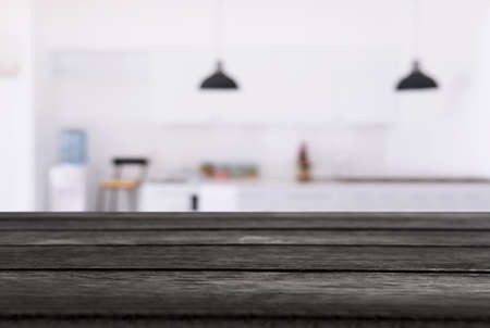 Empty wooden table and blurred background of abstract in front of restaurant or coffee shop for...