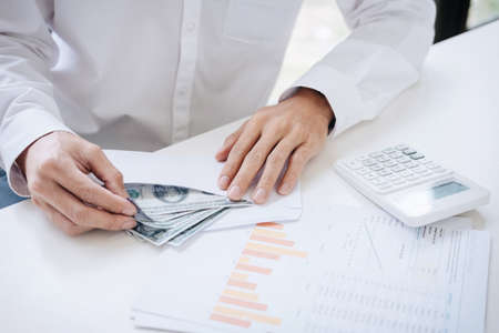 Money in human hands form of dollar bills, Businessman is counting money.