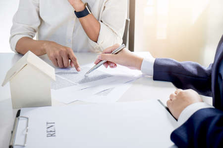 Real estate broker residential agent being analysis and making the decision a home estate loan to customer and waiting for reply to finish house and car rent listing contract.の写真素材