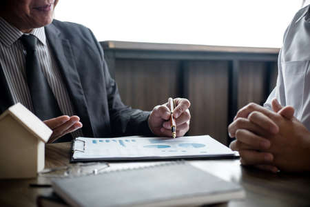 Real estate broker agent being analysis and making the decision a home estate loan to customer to...