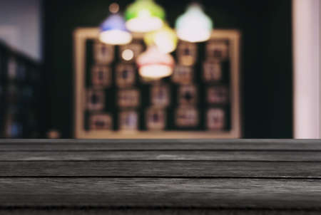Empty wooden table and blurred background of abstract in front of restaurant or coffee shop for display of product or for montage.の写真素材