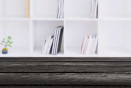 Selected focus empty black wooden table and Library or Bookstore blur background with bokeh image. for your photomontage or product display.の写真素材