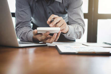 businessman doing finances and calculate working new start up project about cost to real estate...