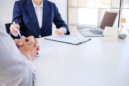 Real estate broker residential agent being analysis and making the decision a home estate loan to customer and waiting for his reply to finish house and car rent listing contract.の写真素材