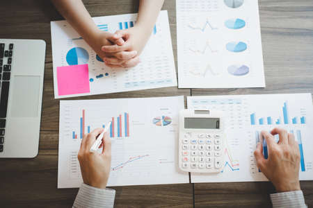 Co working conference, Business team meeting present, investor colleagues discussing new plan financial graph data on office.の写真素材