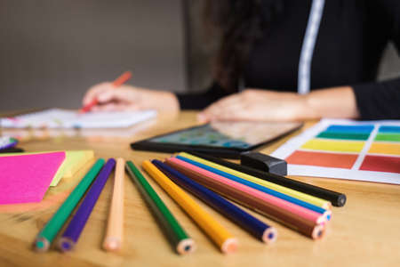 Close up of color pencil ,Young woman dressmaker or designer working as fashion designers and...