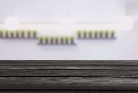 Empty wooden table and blurred background of abstract in front of restaurant or coffee shop for...