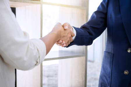 Handshake after good cooperation, Real estate broker residential agent shaking hands with customer after good deal agreement house rent listing contract.の写真素材