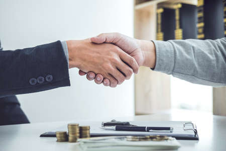 Handshake of cooperation customer and salesman after agreement, successful car loan contract buying or selling new vehicle.の写真素材