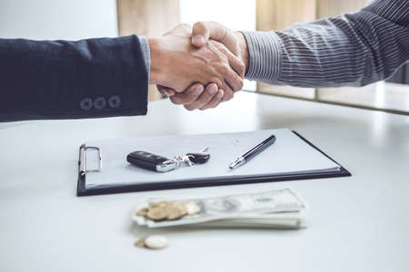 Handshake of cooperation customer and salesman after agreement, successful car loan contract buying or selling new vehicle.の写真素材
