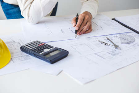 Workplace items tools for project, Architect or Engineer working on blueprint for architectural project in progress, construction and structure concept.の写真素材