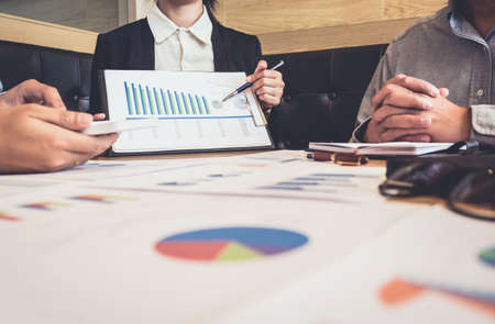Meeting and greeting, Business team colleagues discussing working analysis with financial data and marketing growth report graph in team, Meeting Talking Brainstorming Communication Concept.の写真素材