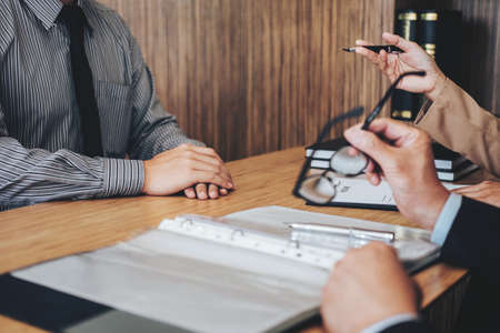 Two senior managers reading a resume during a job interview
