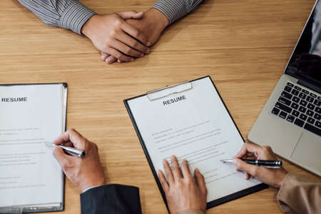 Two senior managers reading a resume during a job interviewの写真素材