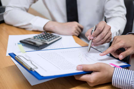 Two business team working and discussing Financial investment on report with calculate Analyze...