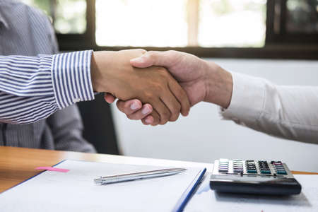 Finishing up a meeting, Two Business handshake of collaboration after discussing good deal of...
