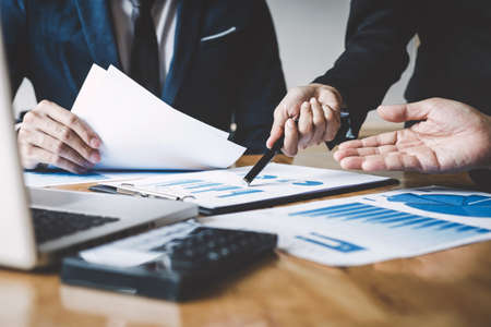 Executive team discussing the charts and graphs working in business strategy and financial plan to investment profit, discussing working analysis with financial data and marketing growth report.の写真素材