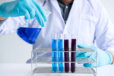 Biochemistry laboratory research, Chemist is analyzing sample in laboratory with equipment and...