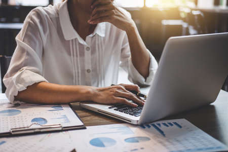 Professional at work, business woman working and analysis on laptop with financial document data graph for new project of business strategy and market growth at workplace.の写真素材