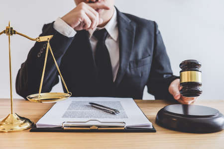 Judge gavel with scales of justice, professional male lawyers or counselor working having at law...
