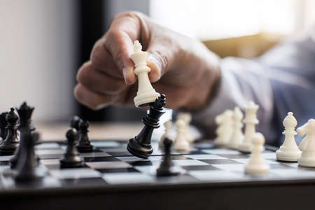 Businessman's hand playing chess game to development analysis new strategy plan, business strategy...