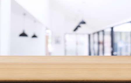 Empty wooden table and blurred background of abstract in front of coffee shop or restaurant for display of product or for montage.の写真素材