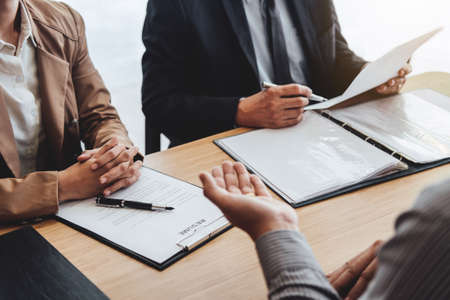 Business man explaining about his profile to two senior manager sitting in during job Interview, interview the job and hiring.の写真素材