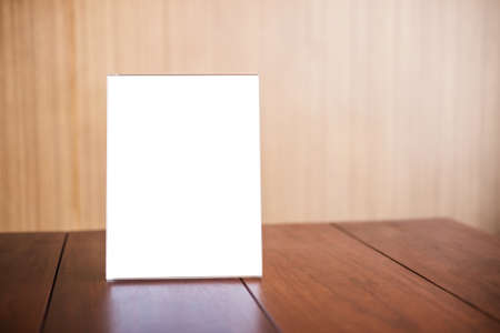 Mock up blank menu frame on table in coffee shop stand for your text of display your product.の写真素材