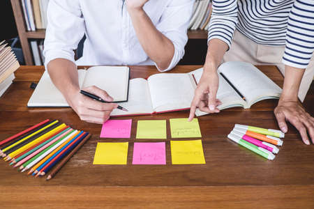 Tutor books with friends, Young students campus or classmates helps friend catching up workbook and...