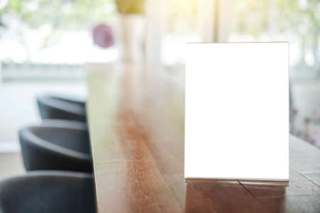 Mock up blank menu frame on table in coffee shop stand for your text of display your product.の写真素材