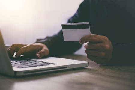 Man typing laptop for online shopping and pay by credit card, Online payment and shopping concept.